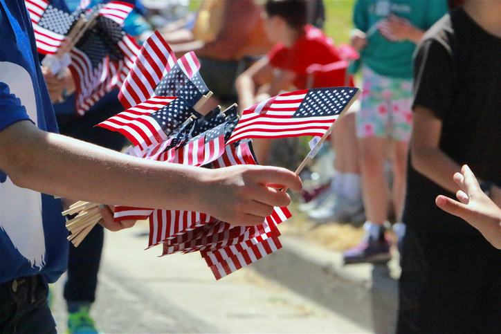 Realtor giving out hand held flags promoting his information 